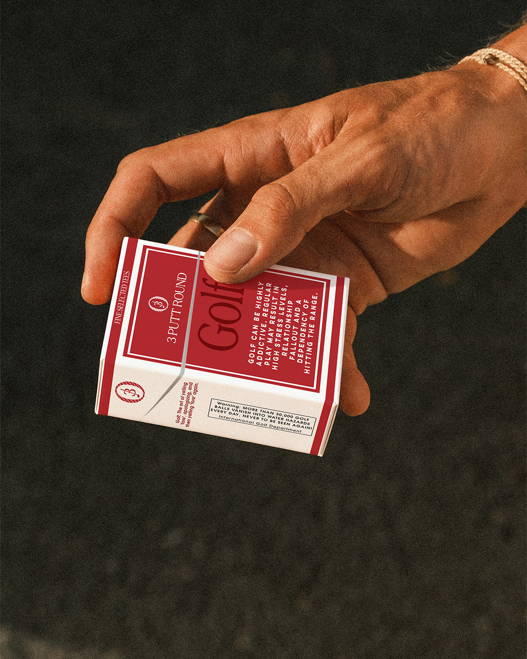 Red Golf Addiction Tees pack by Three Putt Round, featuring multiple standard-sized golf tees on a white background.
