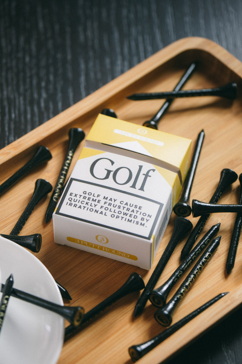 Set of three gold golf tees from Three Putt Round's Golf Addiction Tee Pack, featuring sleek design and custom branding.